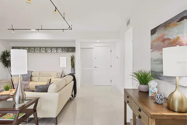 a living room with furniture and a potted plant