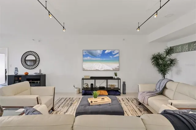 a living room with furniture and a clock