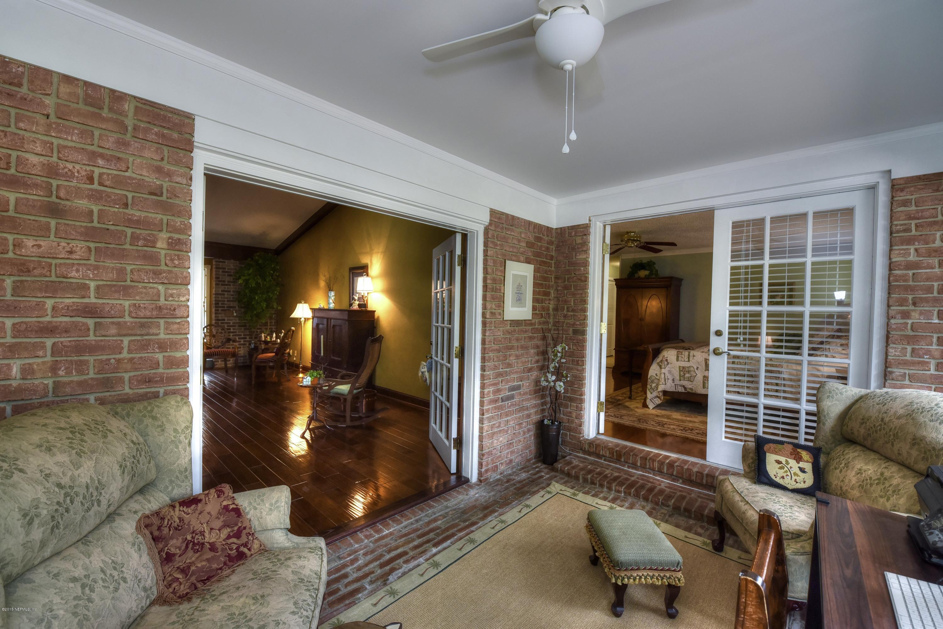 9641 Beauclerc Bluff Road Jacksonville, FL 32257 - Photo 22 of 42 a view of a lobby with furniture and floor to ceiling window
