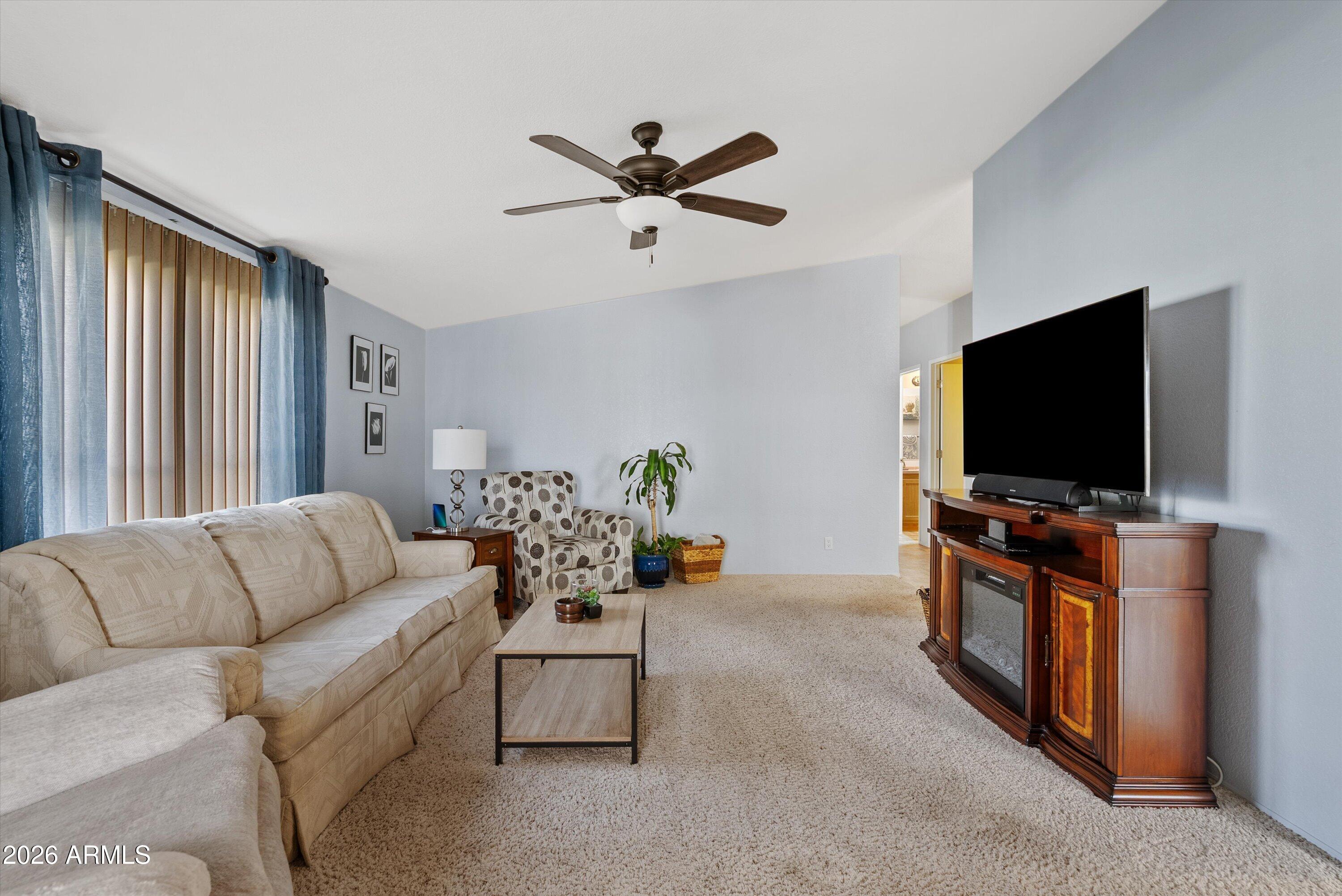 3700 South Tomahawk Road, Unit 91 Apache Junction, AZ 85119 - Photo 8 of 29 a living room with furniture and a flat screen tv