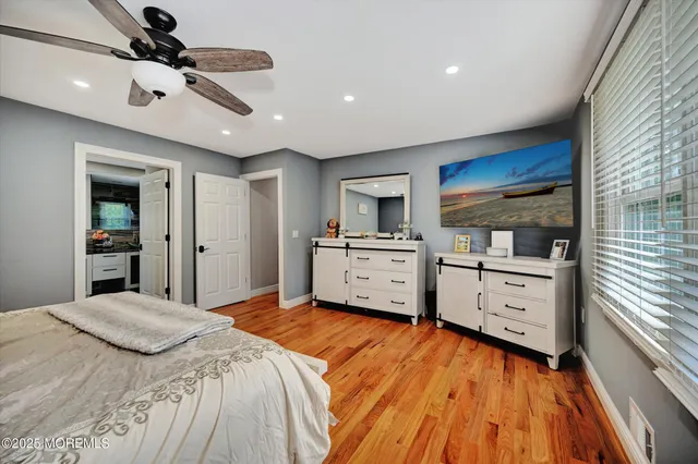 a spacious bedroom with a bed and a cabinets