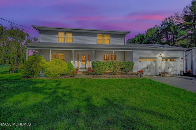 a front view of house with yard and green space