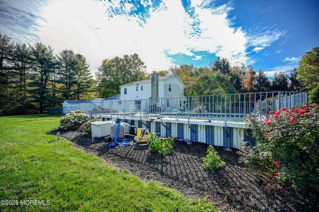 a view of a house with backyard and sitting area