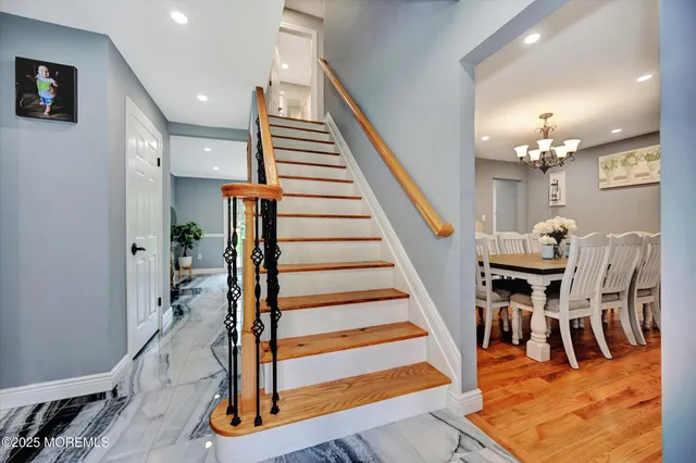 a view of entryway and hall with wooden floor