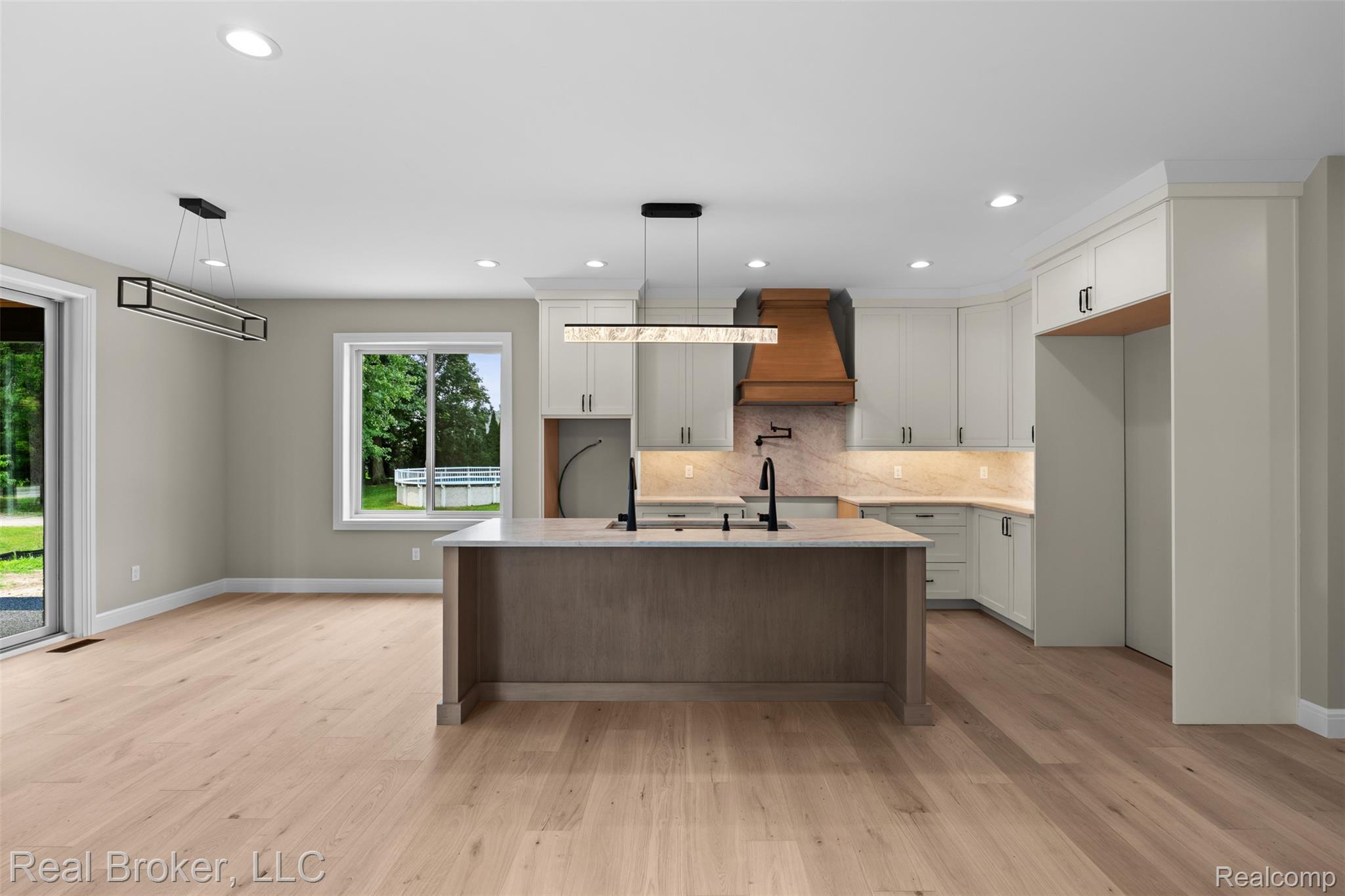 12114 22 Mile Road Utica, MI 48315 - Photo 17 of 70 Gourmet kitchen with custom cabinetry, a central island, wood-finish flooring, and a large window