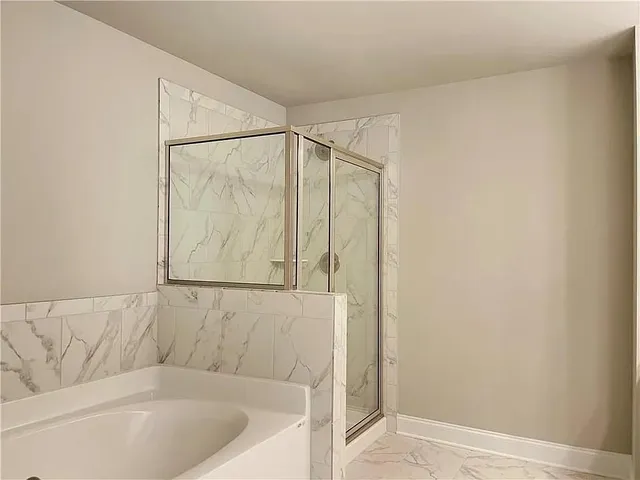 a bathroom with a bathtub and a shower