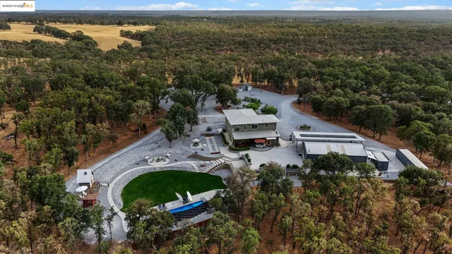 an aerial view of a house with outdoor space