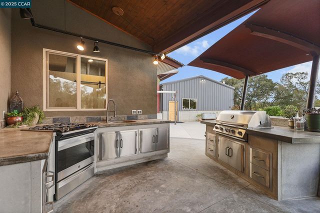 a kitchen with stainless steel appliances granite countertop a stove and a sink