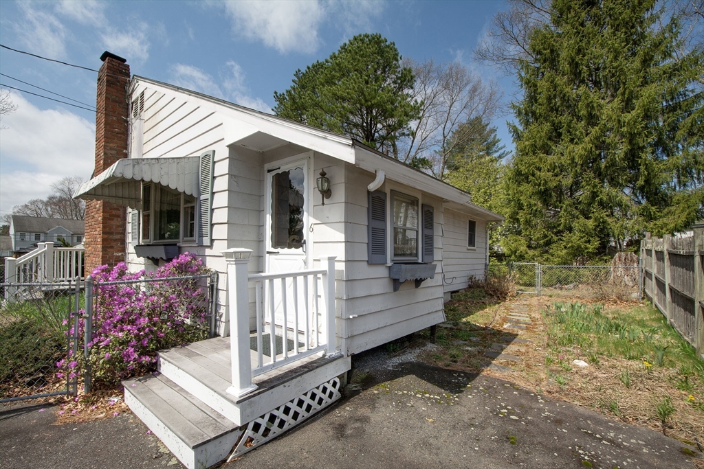 6 Clover Road Holbrook, MA 02343 - Photo 4 of 26 a front view of a house with a garden