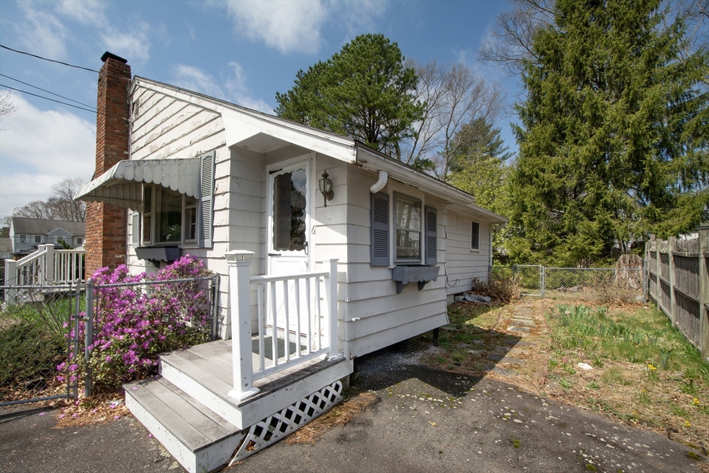 6 Clover Road Holbrook, MA 02343 - Photo 5 of 26 a front view of a house with a garden
