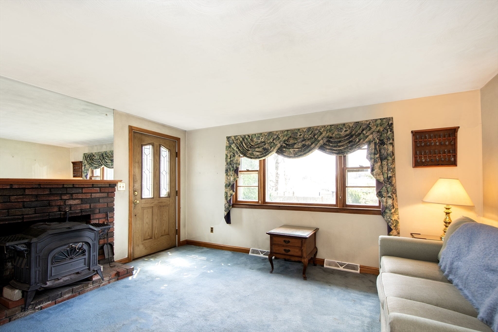 6 Clover Road Holbrook, MA 02343 - Photo 8 of 26 a living room with furniture and a fireplace