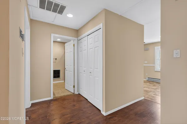 a view of a hallway with wooden shelves