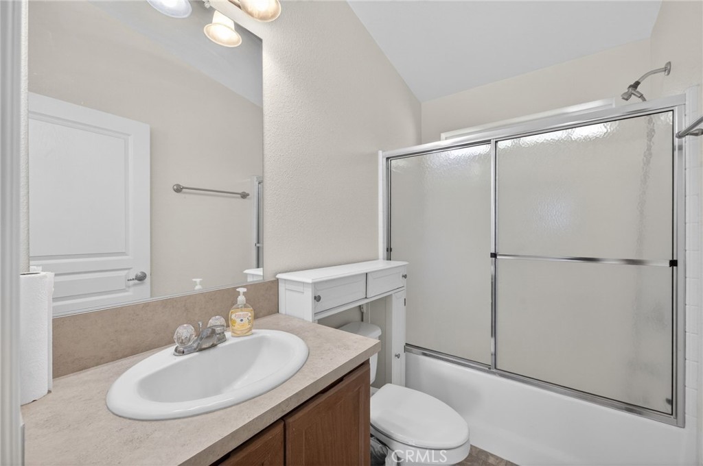 39230 Grassy Road Temecula, CA 92592 - Photo 16 of 33 a bathroom with a sink toilet vanity and shower
