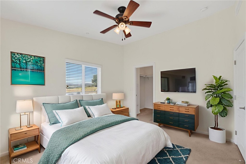 39230 Grassy Road Temecula, CA 92592 - Photo 19 of 33 a bedroom with a bed a couch and a potted plant