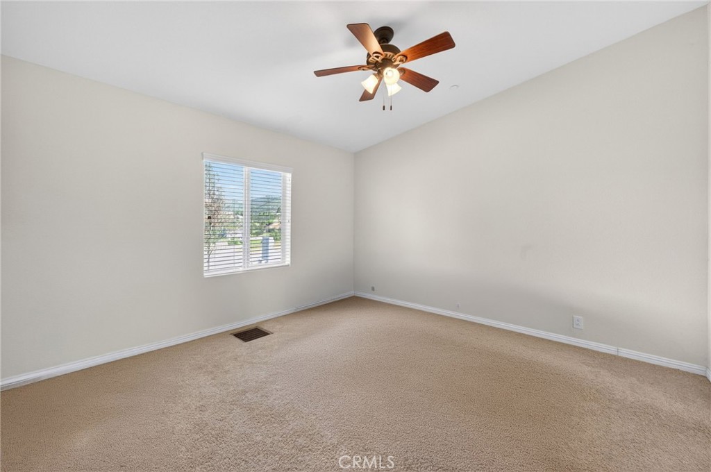 39230 Grassy Road Temecula, CA 92592 - Photo 20 of 33 an empty room with a window and a ceiling fan