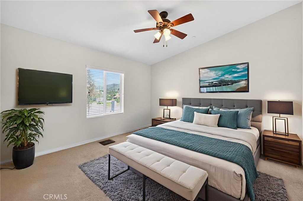 39230 Grassy Road Temecula, CA 92592 - Photo 21 of 33 a bedroom with a large bed and a flat screen tv