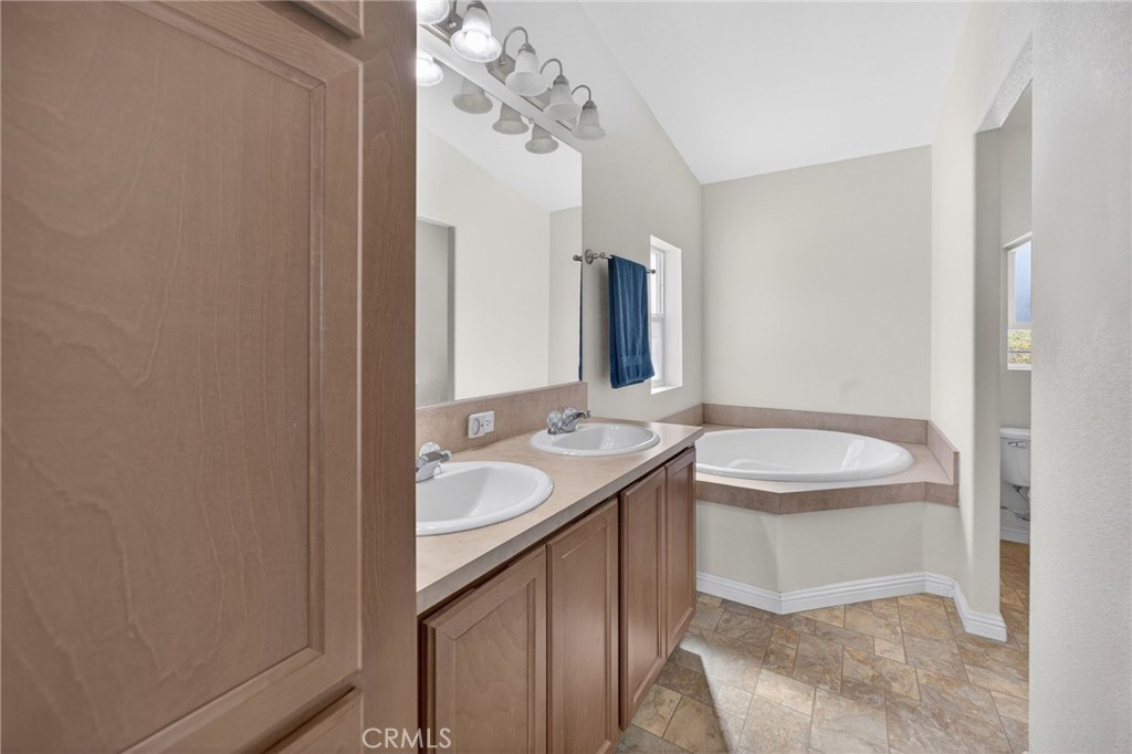 39230 Grassy Road Temecula, CA 92592 - Photo 22 of 33 a bathroom with a sink and a mirror