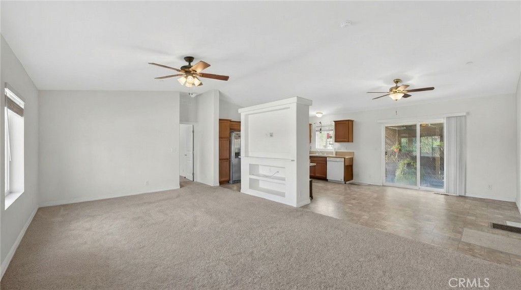 39230 Grassy Road Temecula, CA 92592 - Photo 7 of 33 a view of a big room with windows and chandelier fan