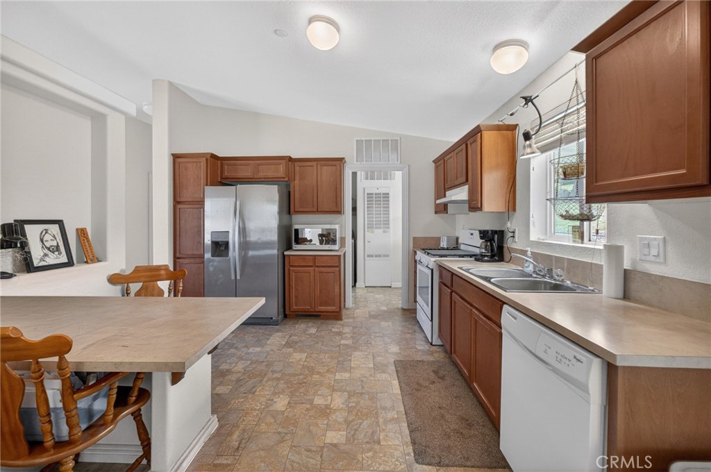 39230 Grassy Road Temecula, CA 92592 - Photo 10 of 33 a large kitchen with a kitchen island a sink stainless steel appliances and cabinets