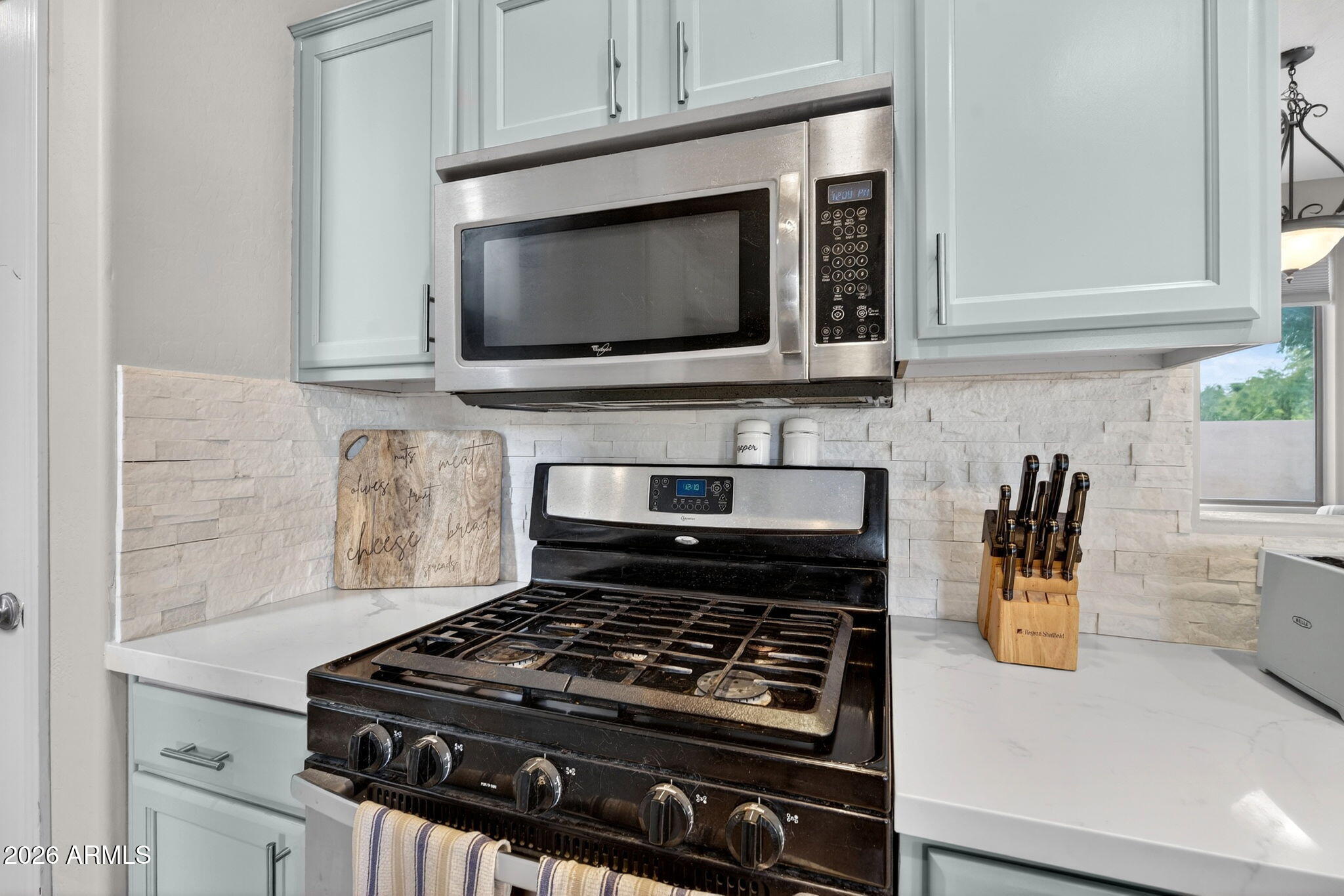 6280 South Sinova Court Gilbert, AZ 85298 - Photo 20 of 64 a kitchen with a stove and a microwave