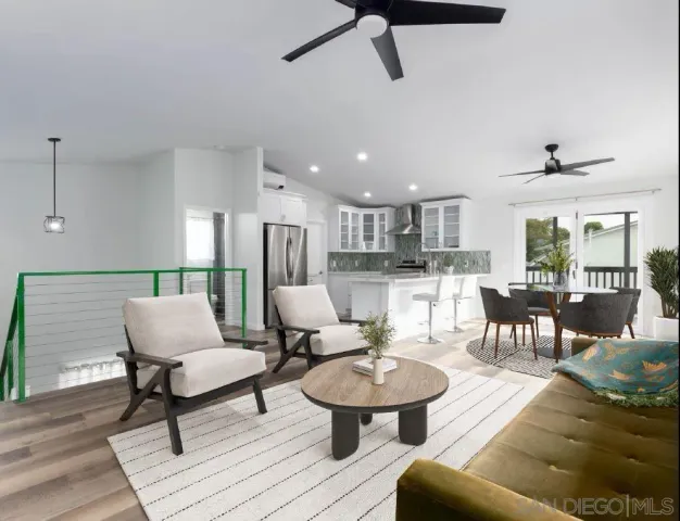 a living room with furniture kitchen and a table