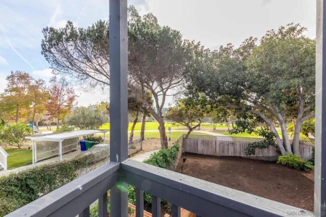 a view of balcony with wooden floor and fence