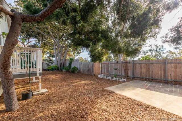 a backyard of a house with a garden and deck