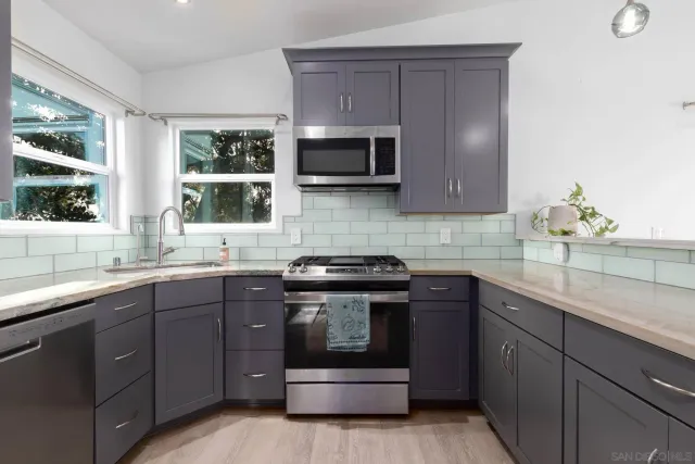 a kitchen with a sink stove and cabinets
