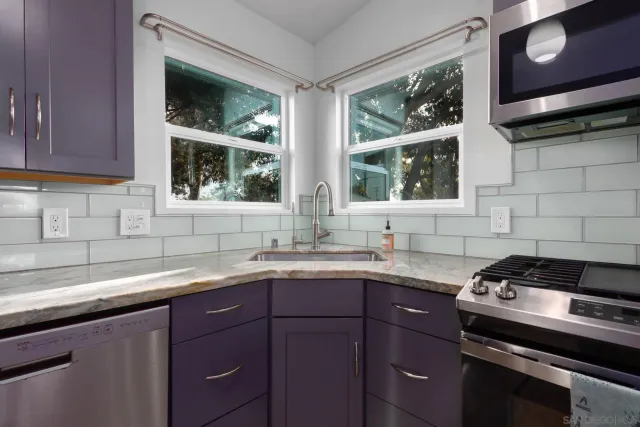 a view of a kitchen with a sink and microwave