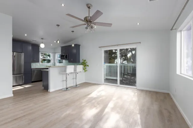 a view of a livingroom with furniture and a ceiling fan