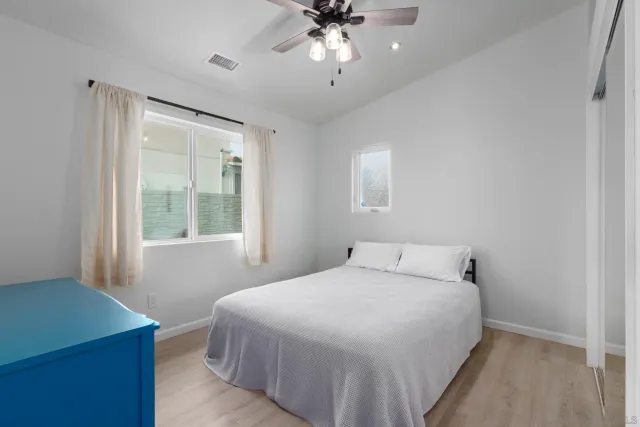 a bedroom with a bed and a window