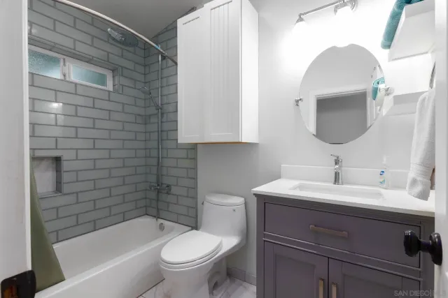 an empty room with a window and wooden floor