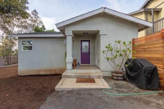 a backyard of a house with table and chairs