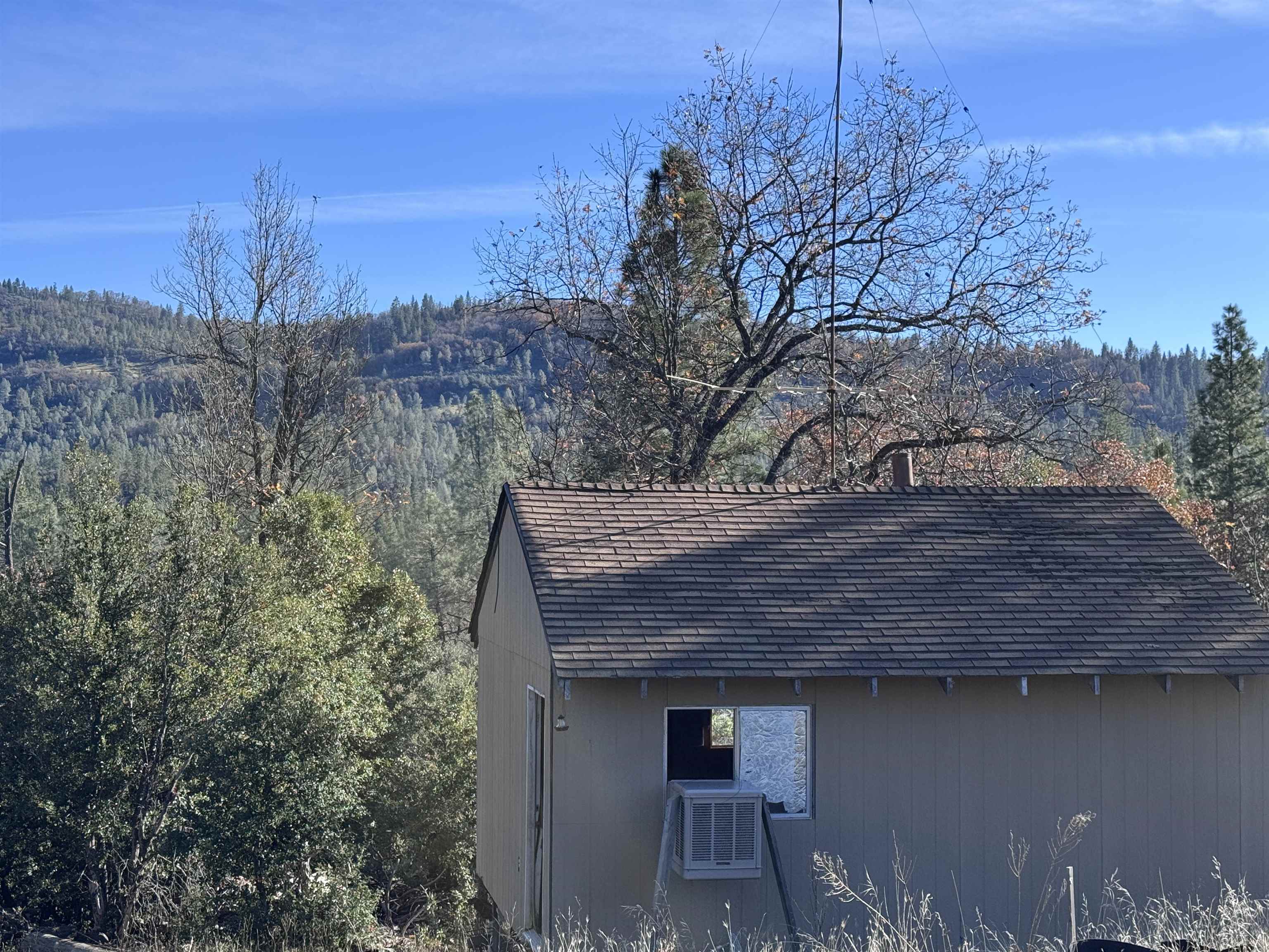 28560 Italian Bar Road Twain Harte, CA 95383 - Photo 3 of 5 a view of a wooden house next to a yard