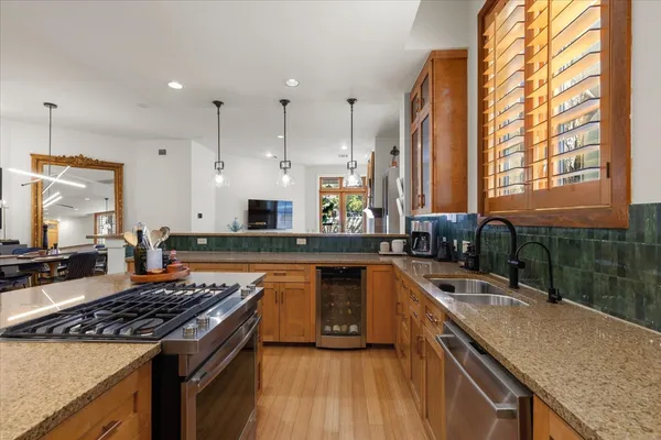 a large kitchen with kitchen island a sink table and chairs