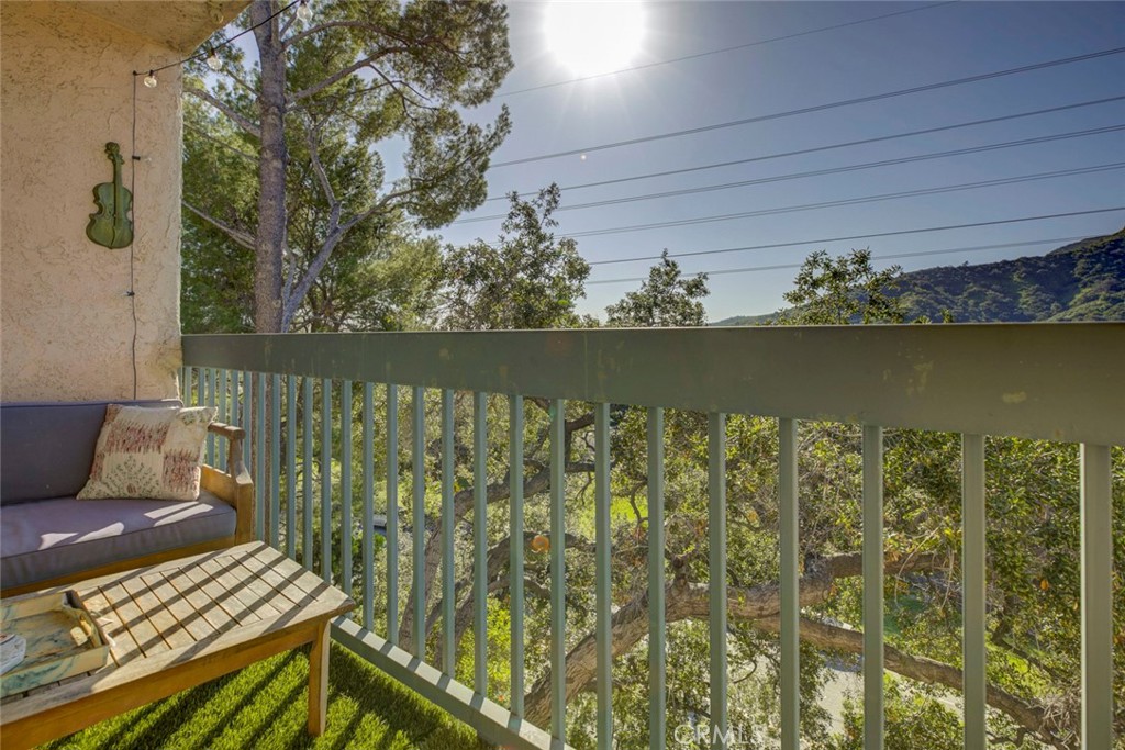 2940 North Verdugo Road, Unit 305 Glendale, CA 91208 - Photo 24 of 26 a view of a balcony with wooden floor and bench