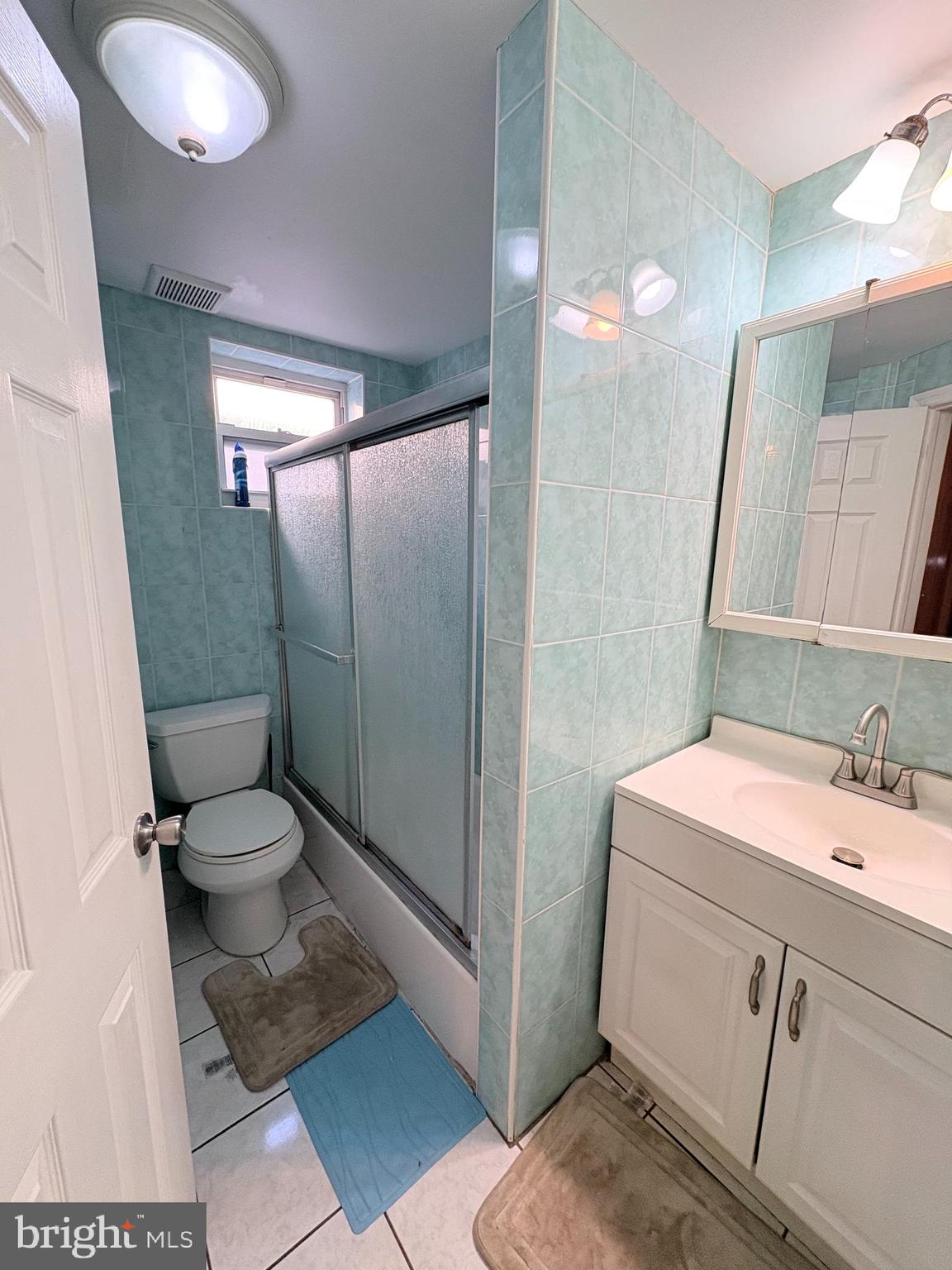 2033 South 9th Street Philadelphia, PA 19148 - Photo 11 of 15 a bathroom with a granite countertop toilet sink and mirror