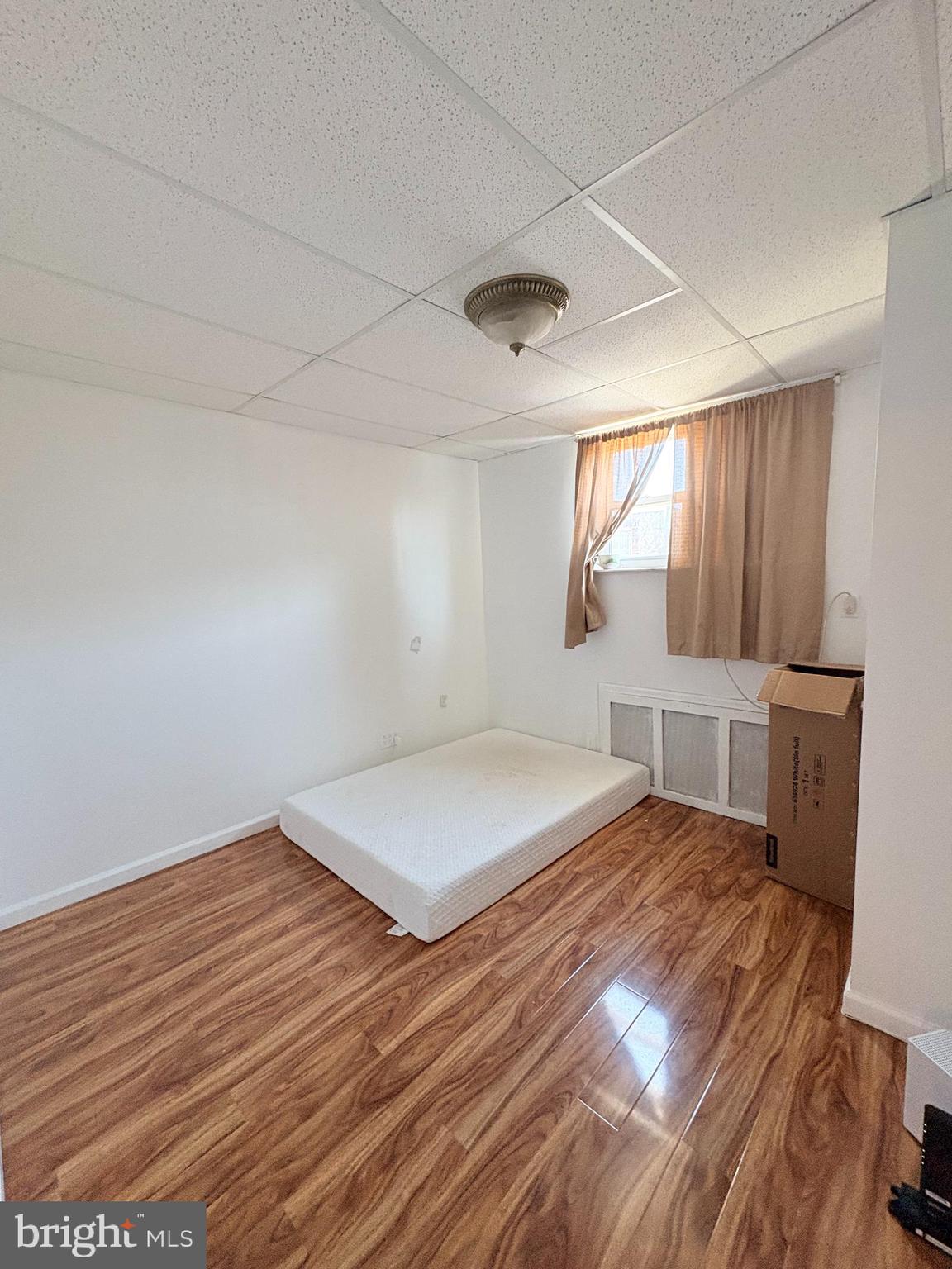 2033 South 9th Street Philadelphia, PA 19148 - Photo 12 of 15 a bedroom with a bed and a window