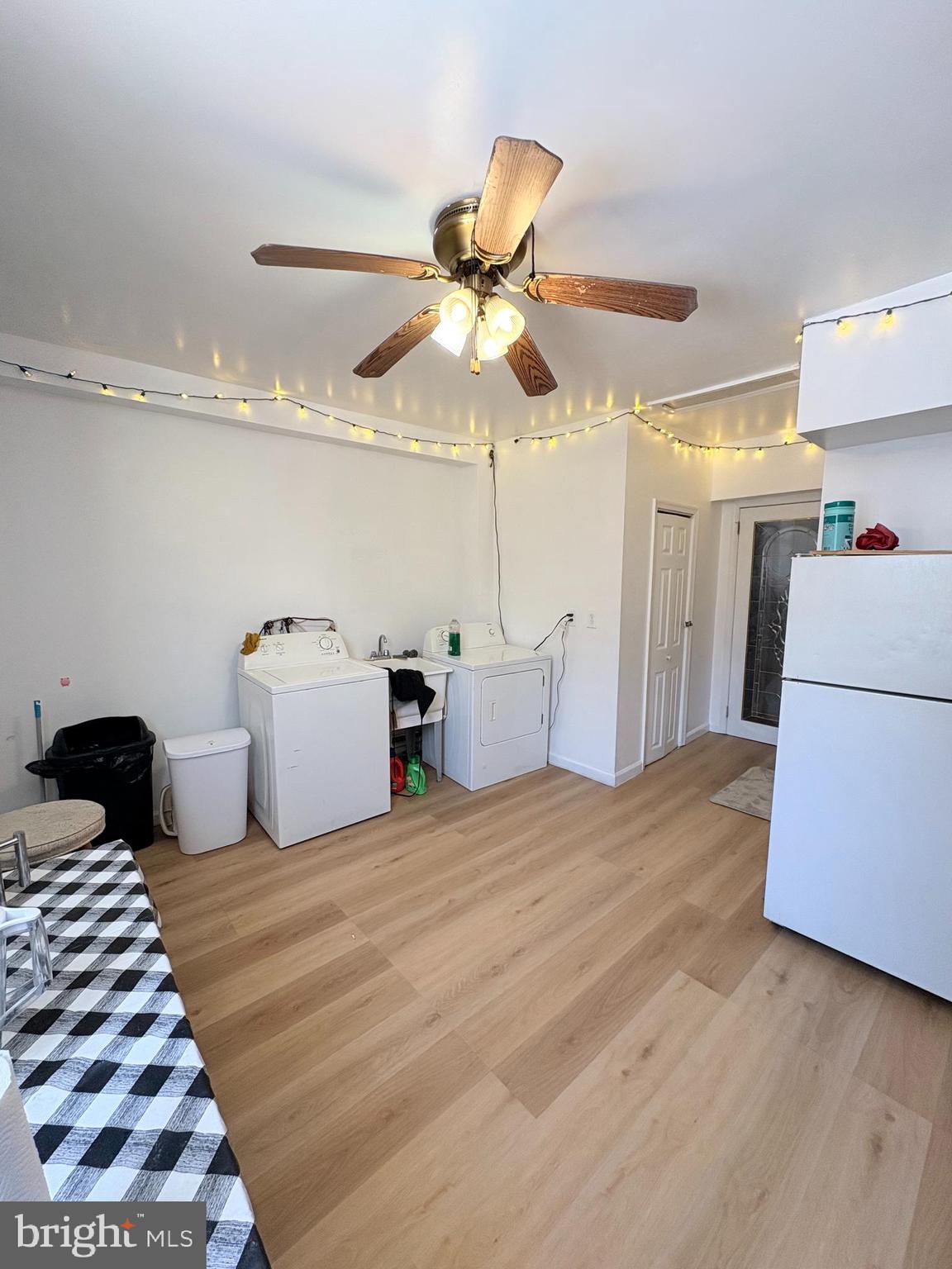 2033 South 9th Street Philadelphia, PA 19148 - Photo 7 of 15 a bedroom with a bed and a chandelier