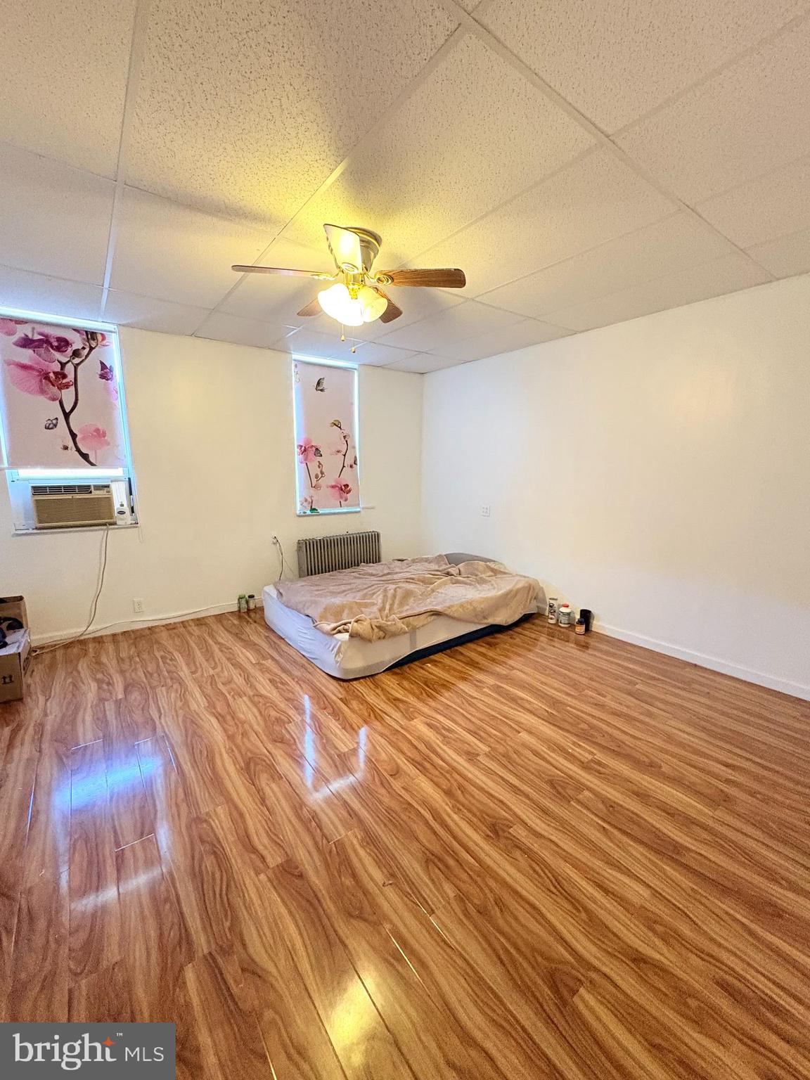 2033 South 9th Street Philadelphia, PA 19148 - Photo 10 of 15 a bedroom with a bed and a wooden floor