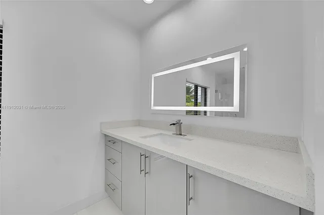 a large white kitchen with a large window