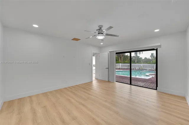 a view of a swimming pool with a patio and a yard