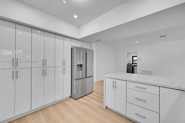 an aerial view of multiple houses with yard