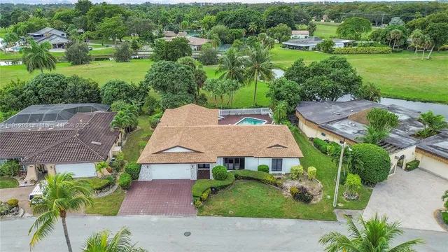 an aerial view of residential houses with outdoor space and street view