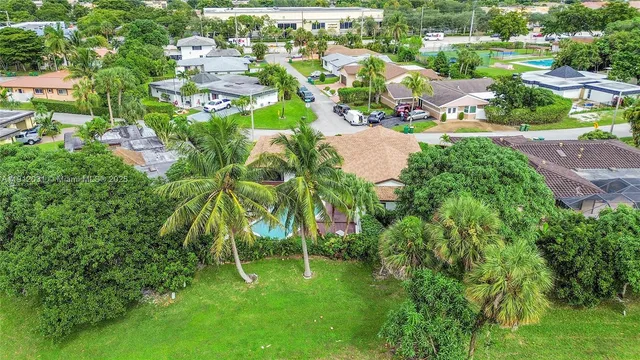 an aerial view of a houses with a yard