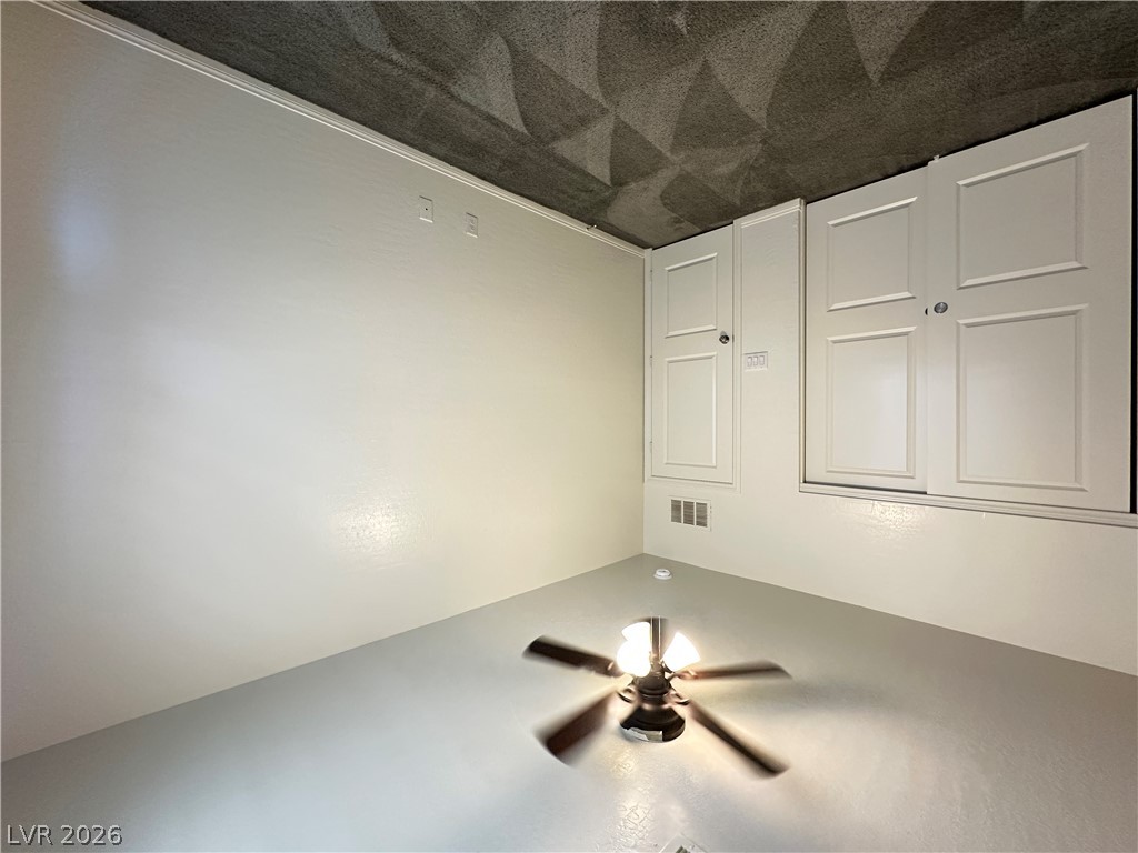6784 Pivot Point Street Las Vegas, NV 89148 - Photo 14 of 27 A versatile space features built-in storage solutions and a functional ceiling fan.