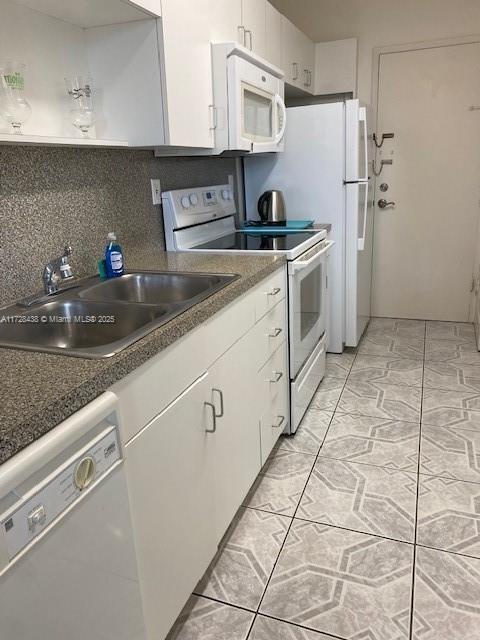 100 Lincoln Road, Unit 616 Miami Beach, FL 33139 - Photo 13 of 31 a kitchen with a sink a stove and refrigerator