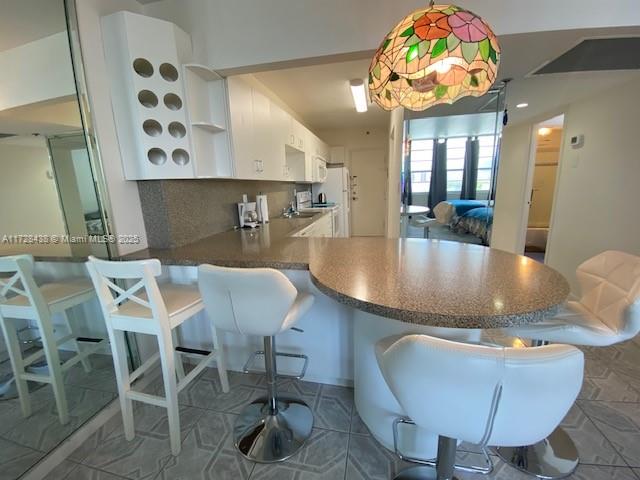 100 Lincoln Road, Unit 616 Miami Beach, FL 33139 - Photo 15 of 31 a dining room with furniture a rug and wooden floor