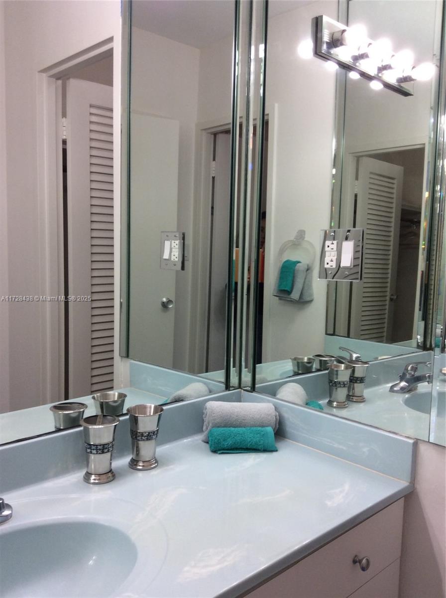 100 Lincoln Road, Unit 616 Miami Beach, FL 33139 - Photo 20 of 31 a bathroom with a sink and a mirror