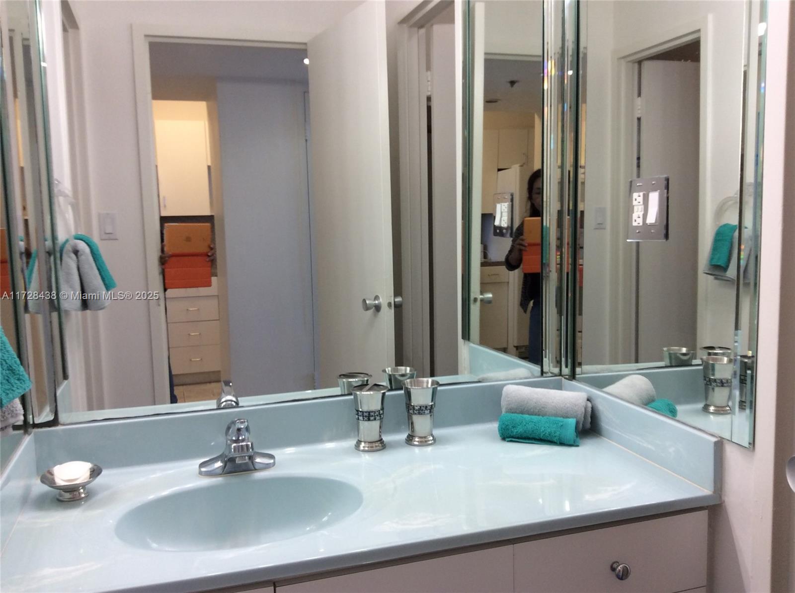 100 Lincoln Road, Unit 616 Miami Beach, FL 33139 - Photo 21 of 31 a bathroom with double vanity sinks and a mirror